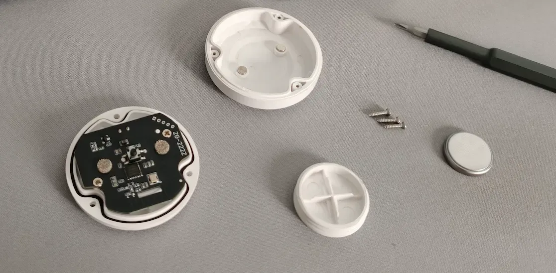 The disassembled Zigbee water leak sensor on a desk